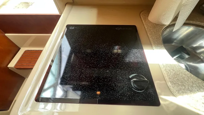 Slide: The Image of Stovetop in 2006 Rampage 30 Offshore boat kitchen, next to a sink. - 37