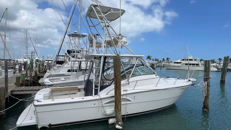 Slide: The Image of 2006 Rampage 30 Offshore boat docked in a marina under a clear blue sky. - 4