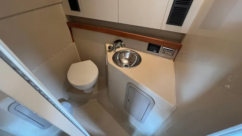 Slide: The Image of 2006 Rampage 30 Offshore boat bathroom with sink and toilet. - 44