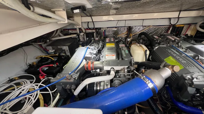 Slide: The Image of Engine room of a 2006 Rampage 30 Offshore boat, showcasing dual engines and wiring. - 47
