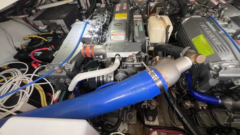 Slide: The Image of Engine compartment of a 2006 Rampage 30 Offshore boat, featuring complex wiring and components. - 48