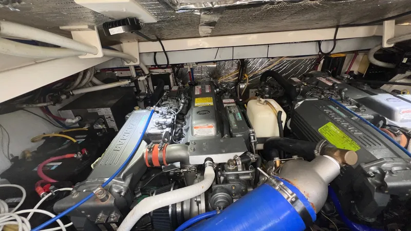 Slide: The Image of Engine room of a 2006 Rampage 30 Offshore boat, showcasing dual engines and mechanical components. - 49