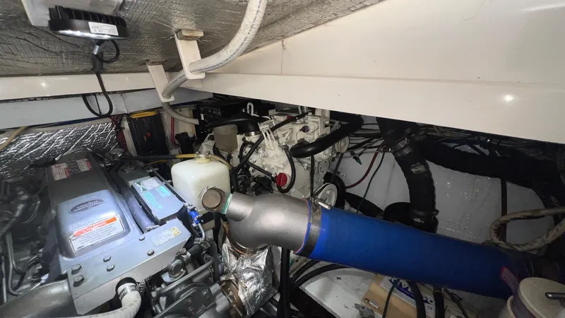 Slide: The Image of Engine room of a 2006 Rampage 30 Offshore boat, showcasing mechanical components and wiring. - 51