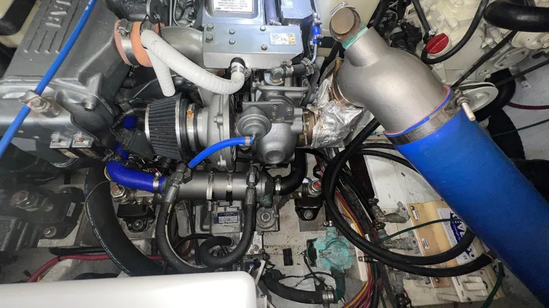 Slide: The Image of Engine compartment of a 2006 Rampage 30 Offshore boat, showcasing mechanical components and wiring. - 52