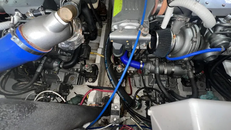 Slide: The Image of Engine compartment of a 2006 Rampage 30 Offshore boat, showcasing mechanical components and wiring. - 53