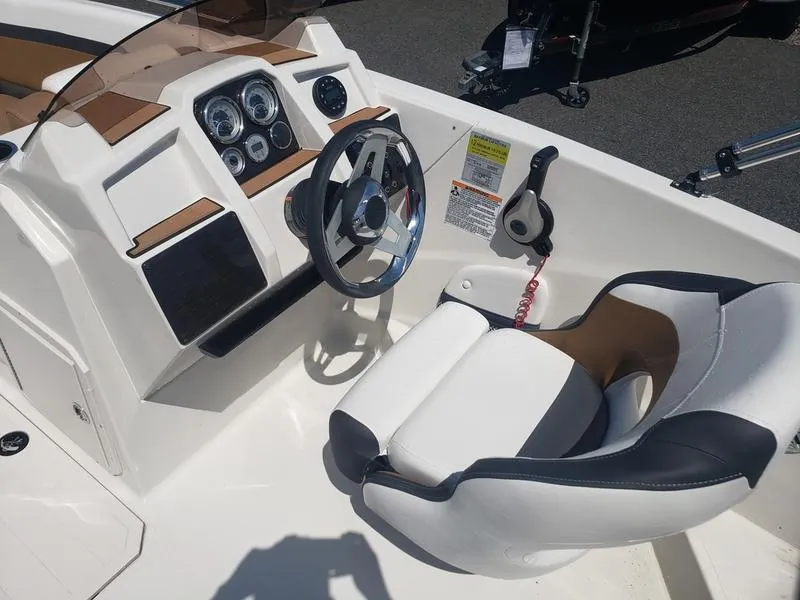 Slide: The Image of 2023 Starcraft SVX 191 OB boat cockpit with steering wheel and control panel. - 11