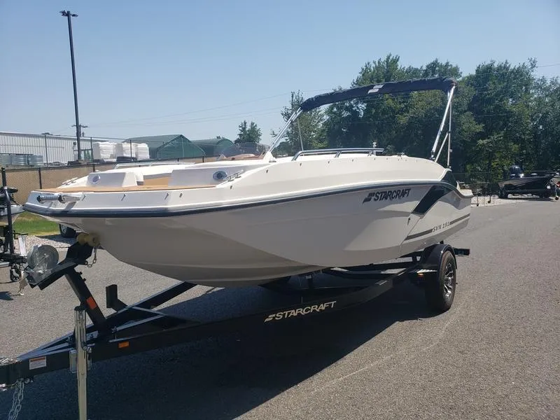 Slide: The Image of 2023 Starcraft SVX 191 OB boat on trailer, parked outdoors. - 3