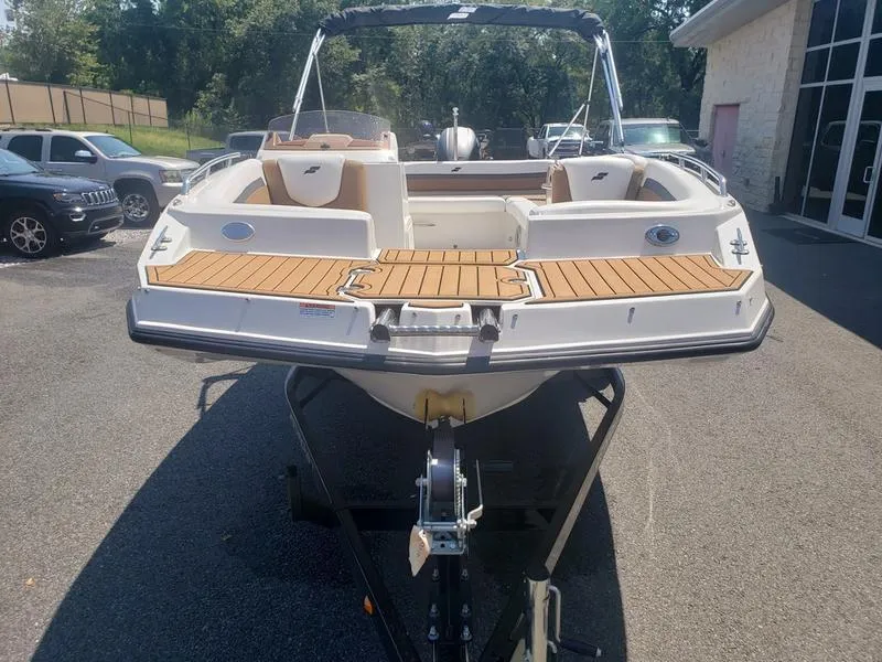 Slide: The Image of 2023 Starcraft SVX 191 OB boat on trailer, featuring spacious deck and seating. - 5