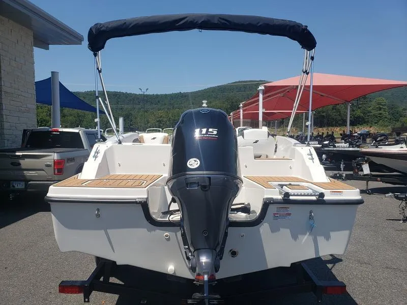 Slide: The Image of 2023 Starcraft SVX 191 OB boat with 115 HP engine, parked outdoors. - 8