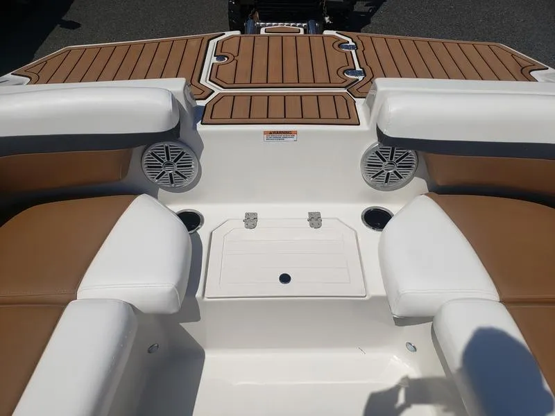 Slide: The Image of 2023 Starcraft SVX 191 OB boat interior with tan and white seating, speakers, and storage. - 9