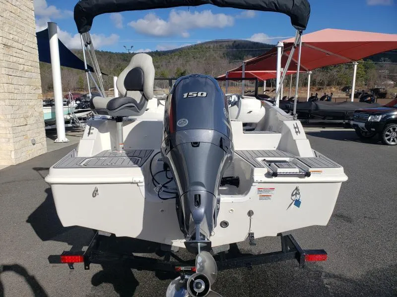 Slide: The Image of 2024 Starcraft SVX 190 OB boat with 150 HP outboard motor, parked outdoors. - 10