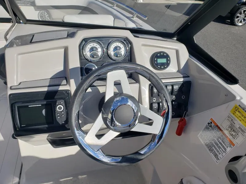 Slide: The Image of 2024 Starcraft SVX 190 OB boat dashboard with steering wheel and gauges. - 21