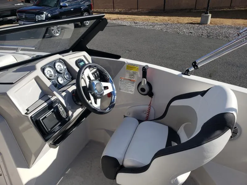 Slide: The Image of 2024 Starcraft SVX 190 OB boat cockpit with steering wheel and gauges. - 22