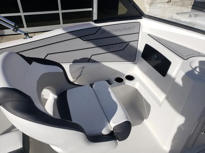 Slide: The Image of 2024 Starcraft SVX 190 OB boat interior with white and black seating. - 23