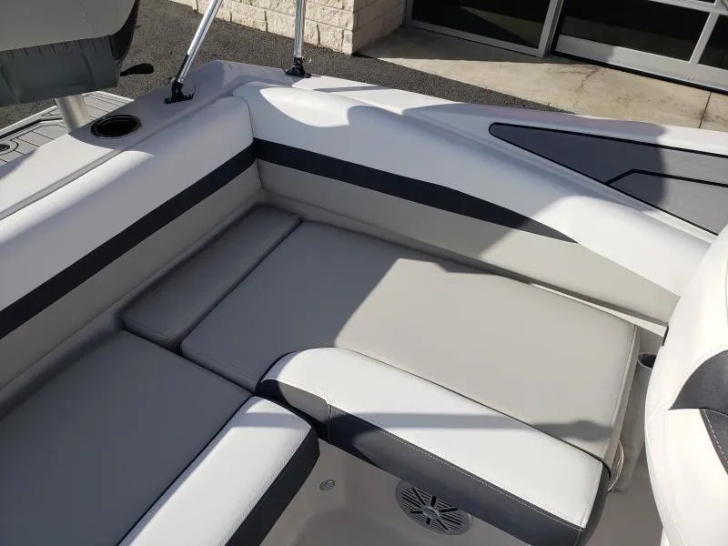 Slide: The Image of 2024 Starcraft SVX 190 OB boat interior with cushioned seating and cup holder. - 24