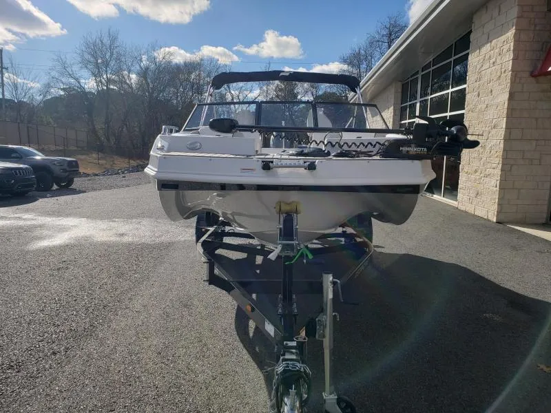 Slide: The Image of 2024 Starcraft SVX 190 OB boat on trailer, parked outdoors under a clear sky. - 7