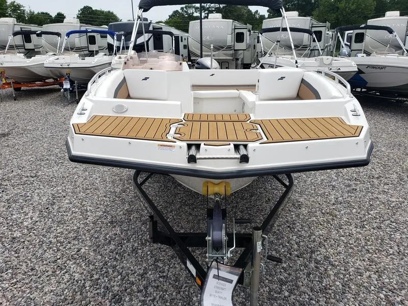 Slide: The Image of 2023 Starcraft SVX 171 OB boat on trailer, displayed in a dealership lot. - 17