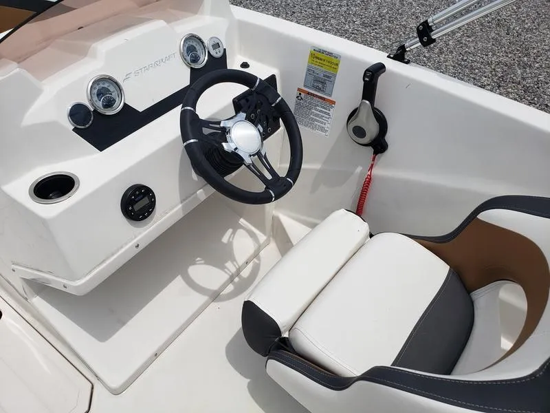 Slide: The Image of 2023 Starcraft SVX 171 OB boat cockpit with steering wheel and control panel. - 4