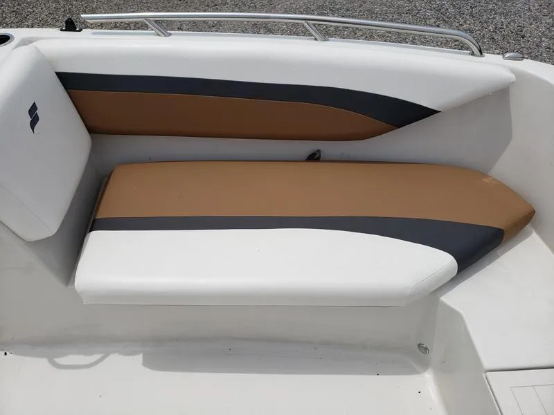 Slide: The Image of 2023 Starcraft SVX 171 OB boat interior with tan and black cushioned seating. - 9