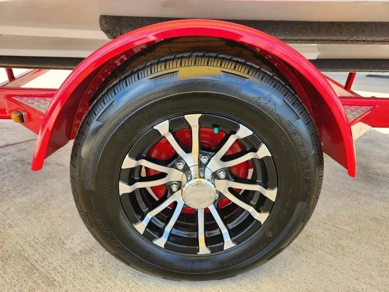 Slide: The Image of Red trailer wheel of 2024 Starcraft SVX 171 OB boat, featuring black and silver rim. - 11