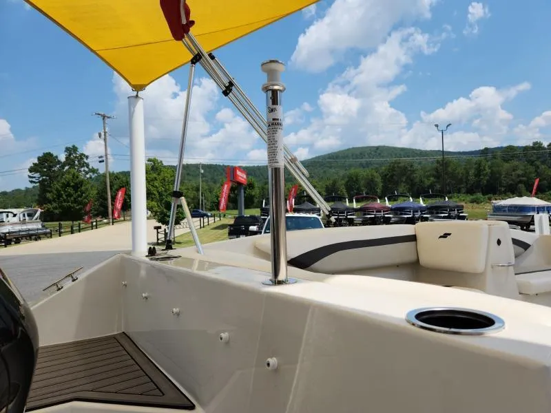 Slide: The Image of 2024 Starcraft SVX 171 OB boat with yellow canopy, parked outdoors under blue sky. - 14