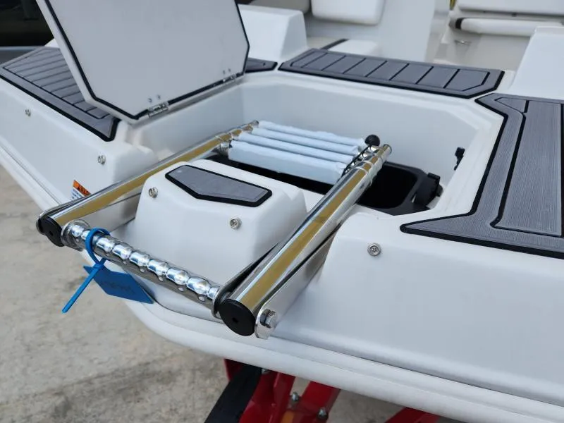 Slide: The Image of 2024 Starcraft SVX 171 OB boat with a foldable swim ladder and storage compartment. - 16