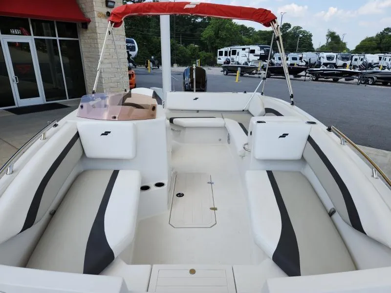 Slide: The Image of 2024 Starcraft SVX 171 OB boat interior with seating, docked outdoors. - 20