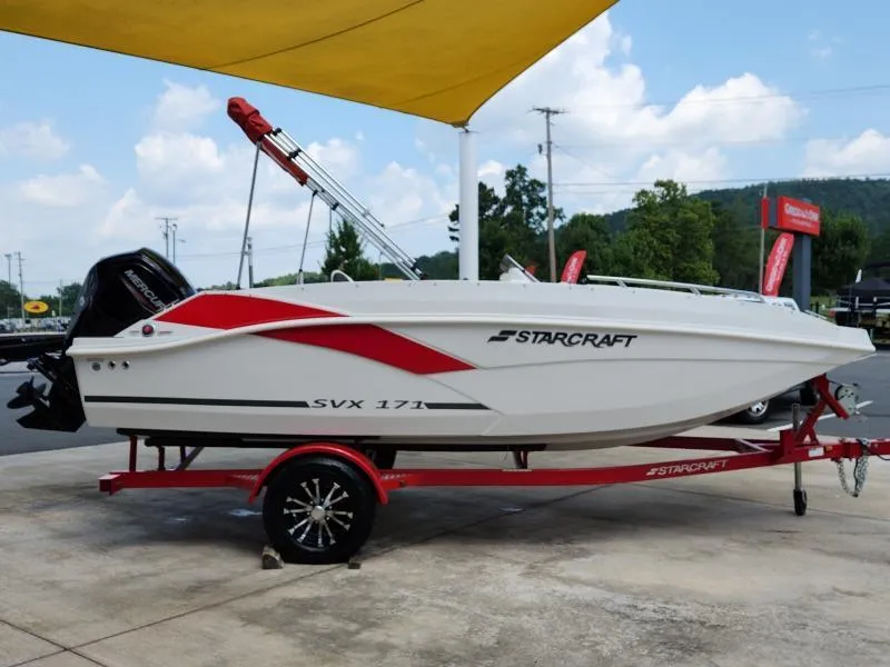 Slide: The Image of 2024 Starcraft SVX 171 OB boat on a red trailer under a yellow canopy. - 22