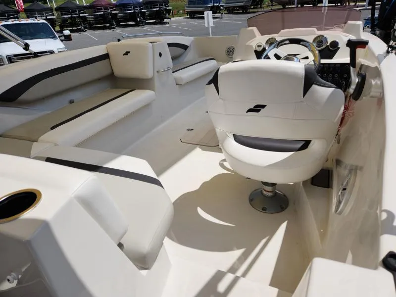 Slide: The Image of 2024 Starcraft SVX 171 OB boat interior with white seating and steering console. - 24