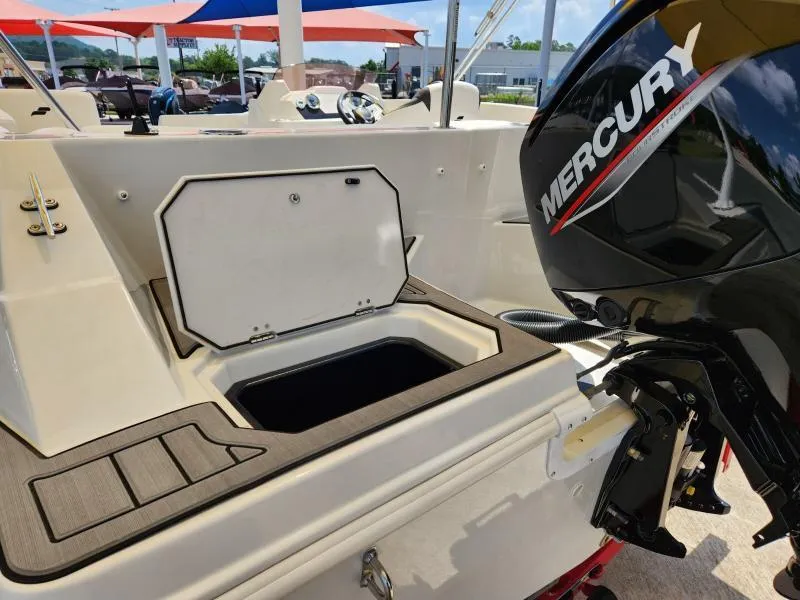 Slide: The Image of 2024 Starcraft SVX 171 OB boat with Mercury outboard motor and open storage compartment. - 6