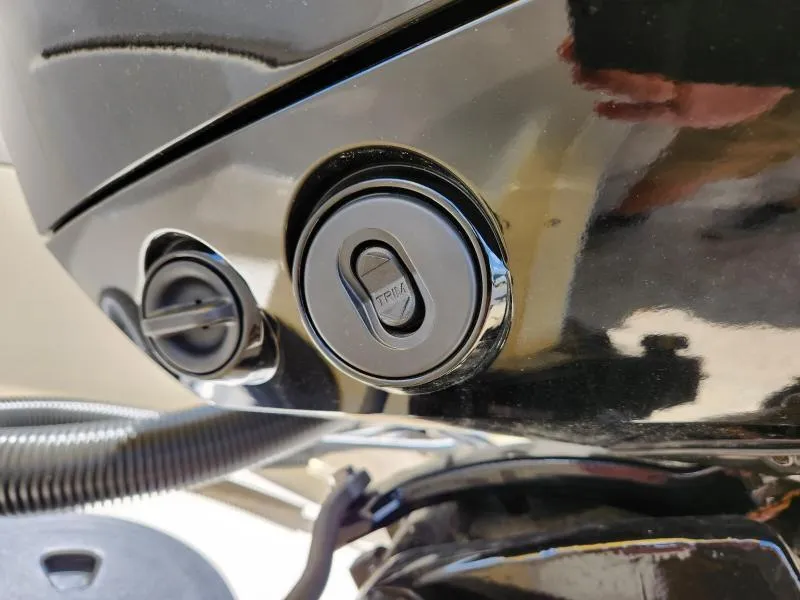 Slide: The Image of Close-up of 2024 Starcraft SVX 171 OB boat trim control buttons. - 7