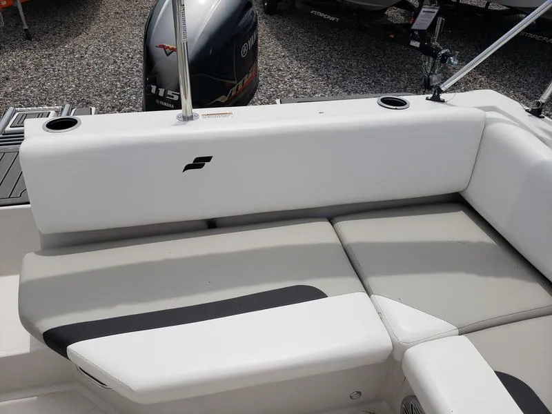Slide: The Image of 2023 Starcraft SVX 171 OB boat interior with cushioned seating and Yamaha outboard motor. - 12