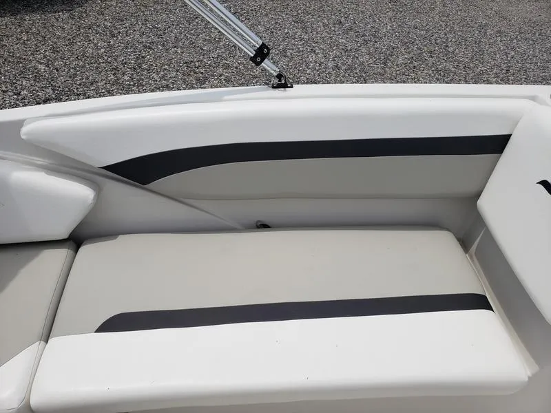 Slide: The Image of 2023 Starcraft SVX 171 OB boat interior seating, white and gray upholstery. - 13