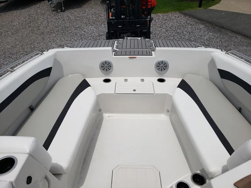 Slide: The Image of 2023 Starcraft SVX 171 OB boat interior with white seating and cup holders. - 18