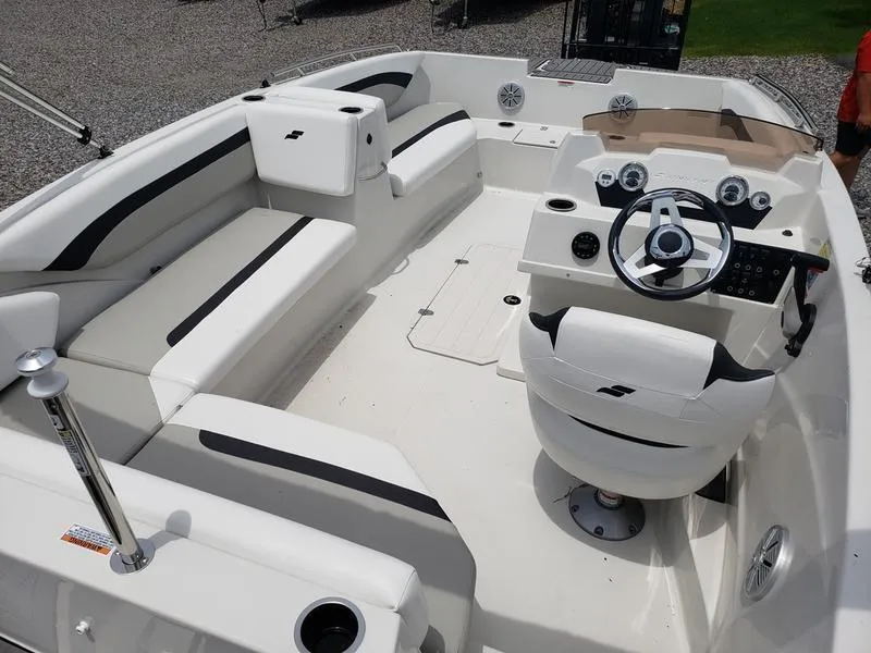 Slide: The Image of 2023 Starcraft SVX 171 OB boat interior with white seating and modern dashboard. - 19