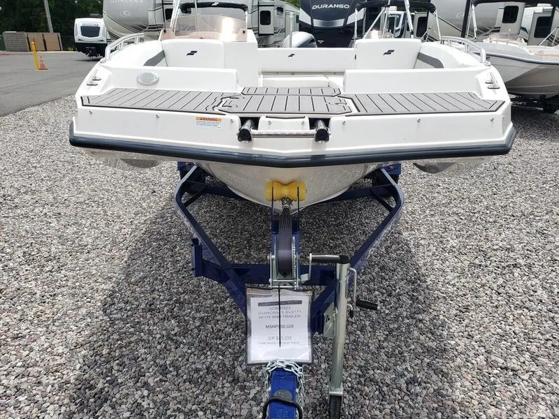 Slide: The Image of 2023 Starcraft SVX 171 OB boat on trailer, displayed on gravel lot. - 4