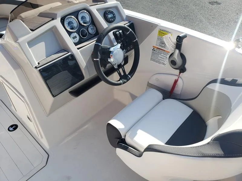 Slide: The Image of 2023 Starcraft SVX191OB boat cockpit with steering wheel and control panel. - 10