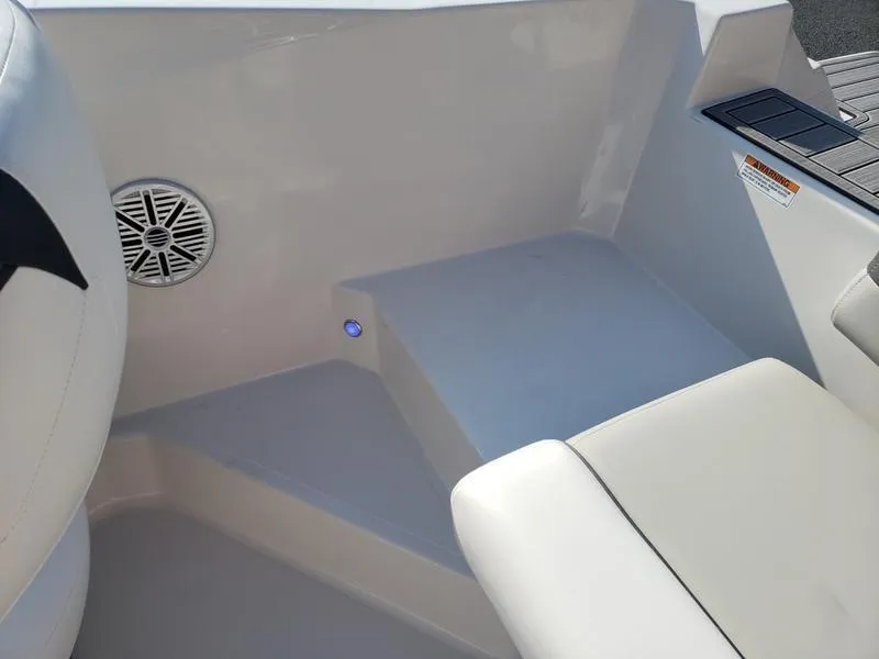 Slide: The Image of Interior of 2023 Starcraft SVX191OB boat, featuring seating and speaker. - 11