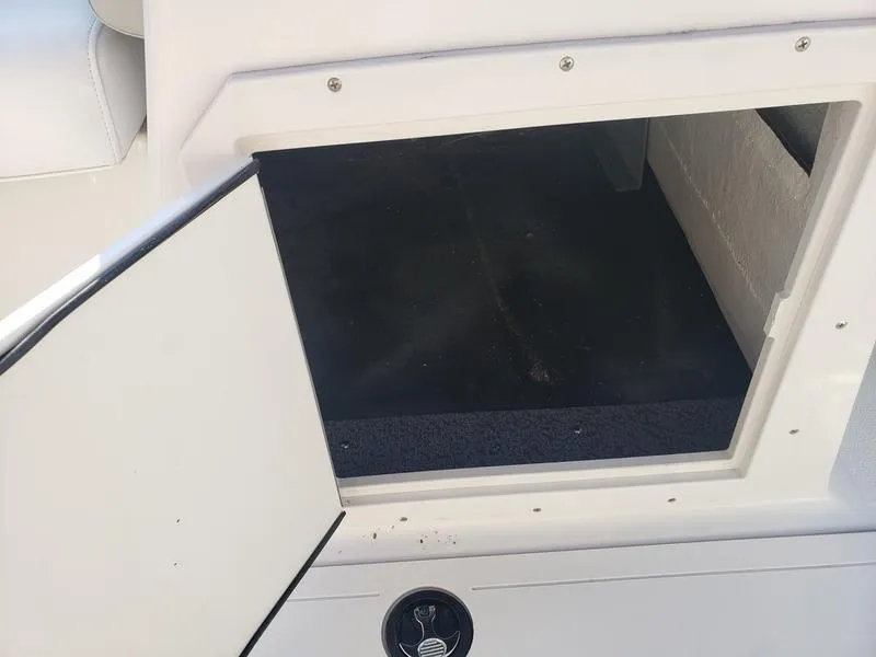 Slide: The Image of Open storage compartment on 2023 Starcraft SVX191OB boat. - 16
