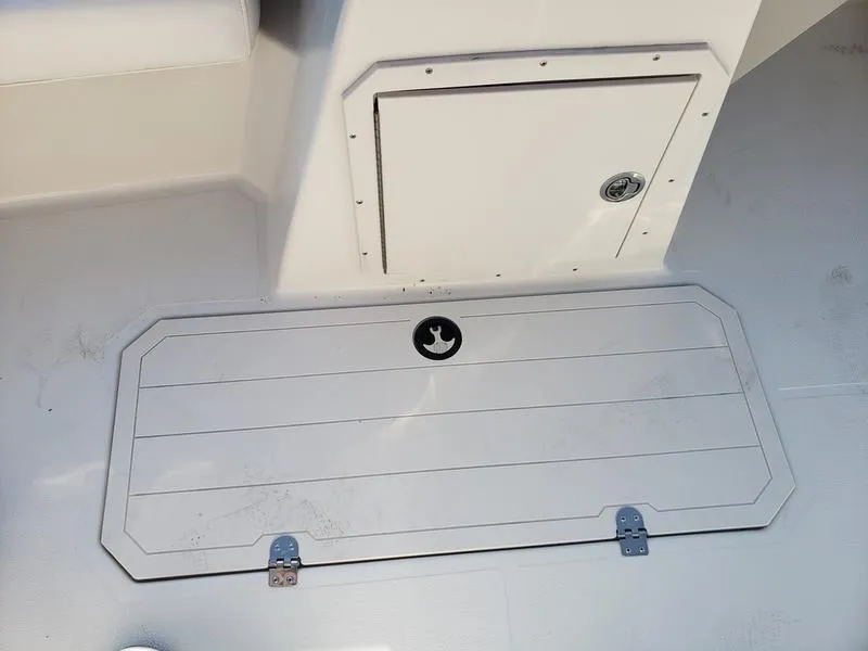 Slide: The Image of 2023 Starcraft SVX191OB boat storage compartment with secure latch and clean design. - 18
