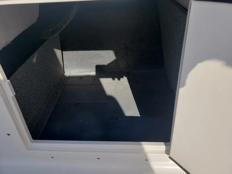 Slide: The Image of Open storage compartment in 2023 Starcraft SVX191OB boat, showing interior space. - 19