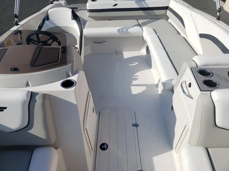 Slide: The Image of 2023 Starcraft SVX191OB boat interior with white seating and steering console. - 21