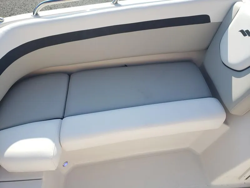 Slide: The Image of 2023 Starcraft SVX191OB boat interior seating with gray upholstery. - 22