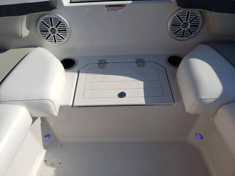 Slide: The Image of 2023 Starcraft SVX191OB boat interior with white seating and built-in speakers. - 24