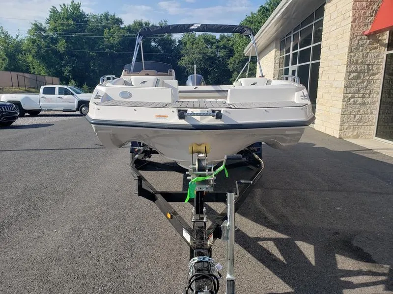 Slide: The Image of 2023 Starcraft SVX191OB boat on trailer, parked outside a building. - 5