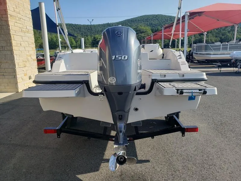 Slide: The Image of 2023 Starcraft SVX191OB boat with 150 HP engine, parked outdoors. - 6