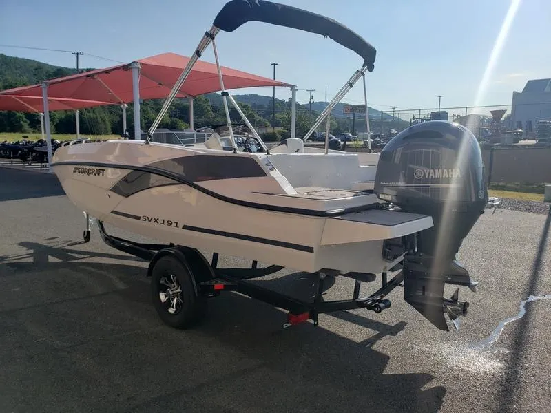 Slide: The Image of 2023 Starcraft SVX191OB boat with Yamaha outboard motor on a trailer, parked outdoors. - 8