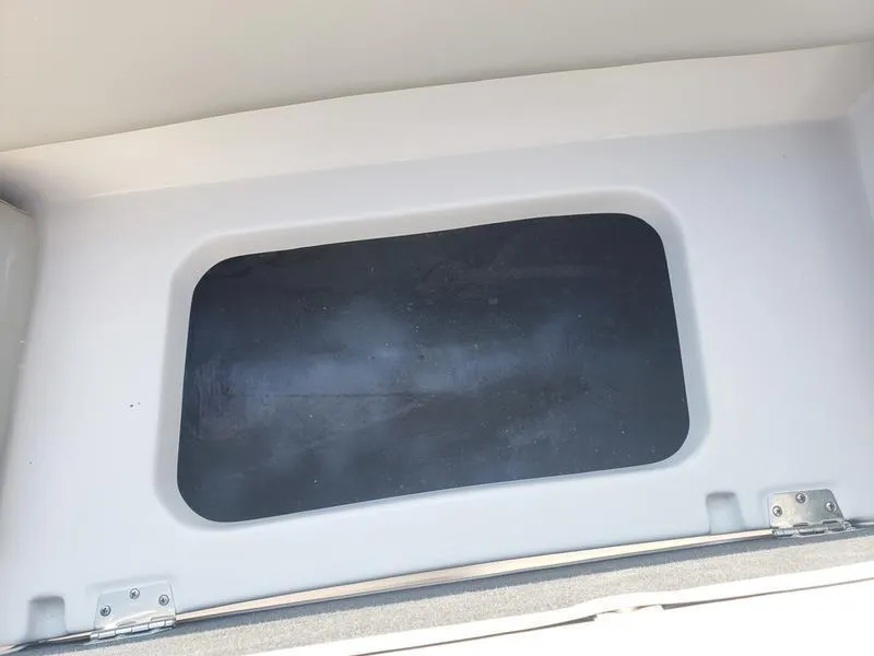 Slide: The Image of Storage compartment of 2023 Starcraft SVX191OB boat, featuring a black mat. - 9