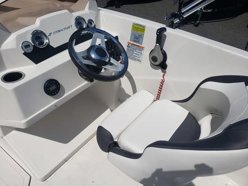 Slide: The Image of 2023 Starcraft SVX 171 OB boat cockpit with steering wheel and controls. - 10