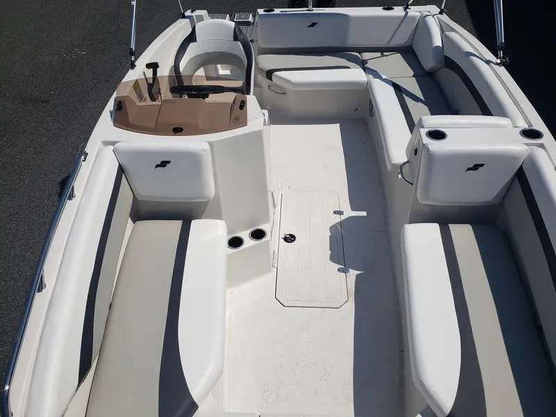 Slide: The Image of 2023 Starcraft SVX 171 OB boat interior with white seating and steering console. - 15